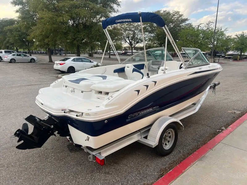 Slide: The Image of 2013 Chaparral 19 Sport H2O boat on a trailer in a parking lot. - 6