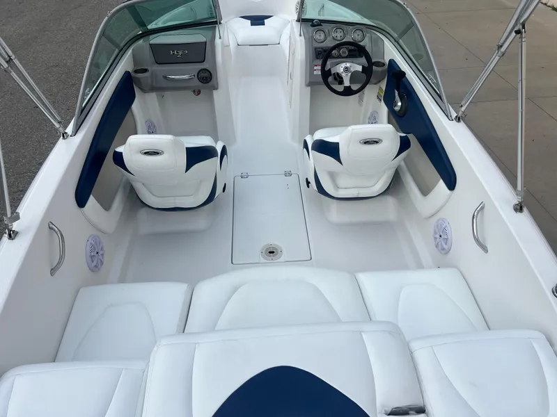 Slide: The Image of 2013 Chaparral 19 Sport H2O boat interior with white and blue seating. - 8
