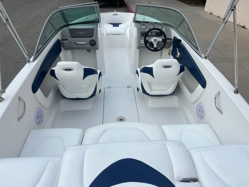 Slide: The Image of 2013 Chaparral 19 Sport H2O boat interior with white and blue seating. - 9