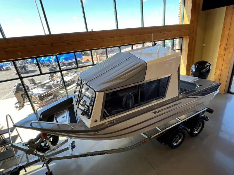 Slide: The Image of 2024 Spartan 185 Astoria boat on trailer in showroom. - 1