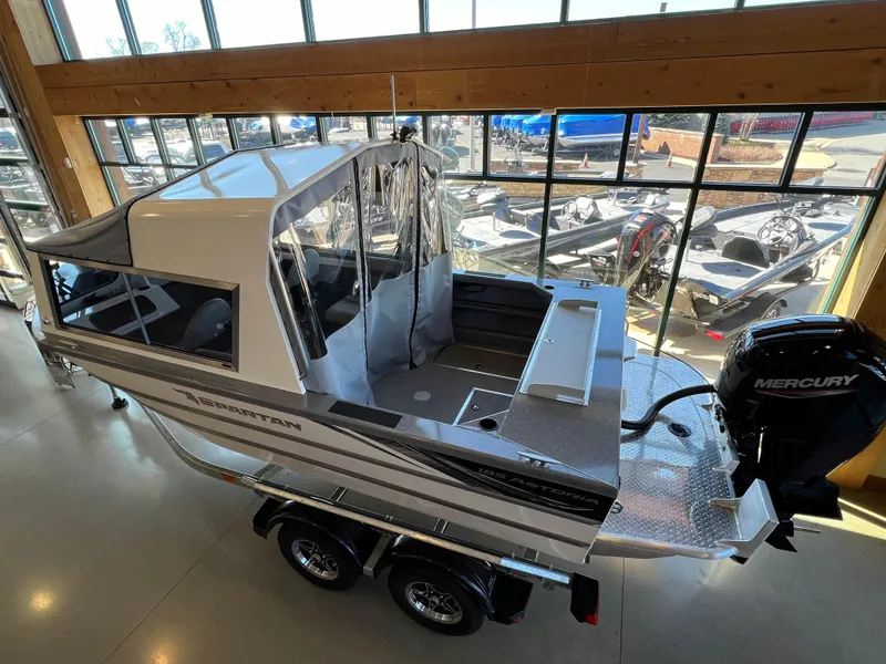 Slide: The Image of 2024 Spartan 185 Astoria boat with Mercury outboard motor in showroom. - 2