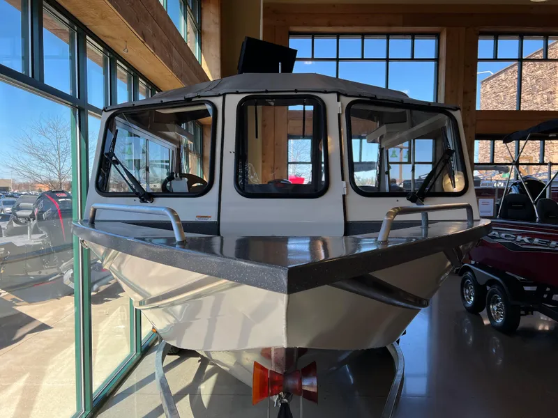 Slide: The Image of 2024 Spartan 185 Astoria boat displayed indoors with large windows. - 4