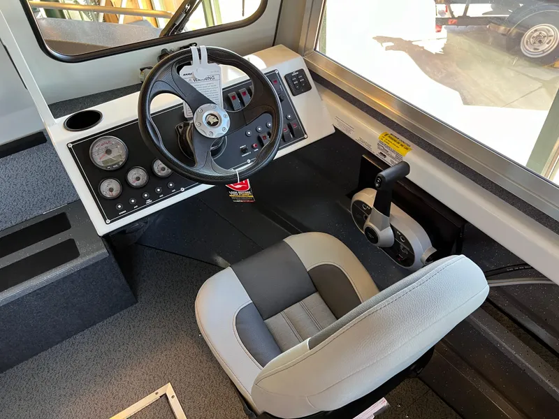 Slide: The Image of 2024 Spartan 185 Astoria boat cockpit with steering wheel and control panel. - 8