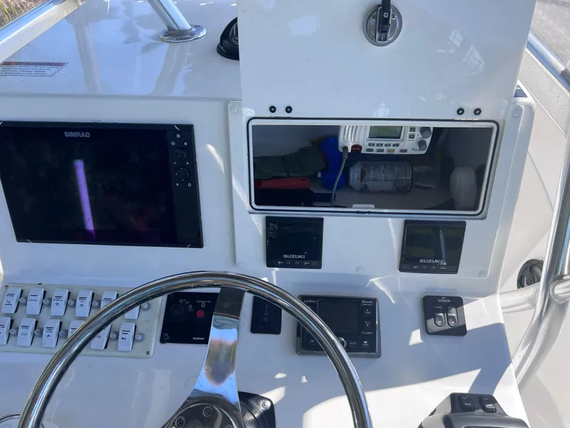 Slide: The Image of 2022 Dusky 278 Center Console boat dashboard with navigation and control systems. - 13