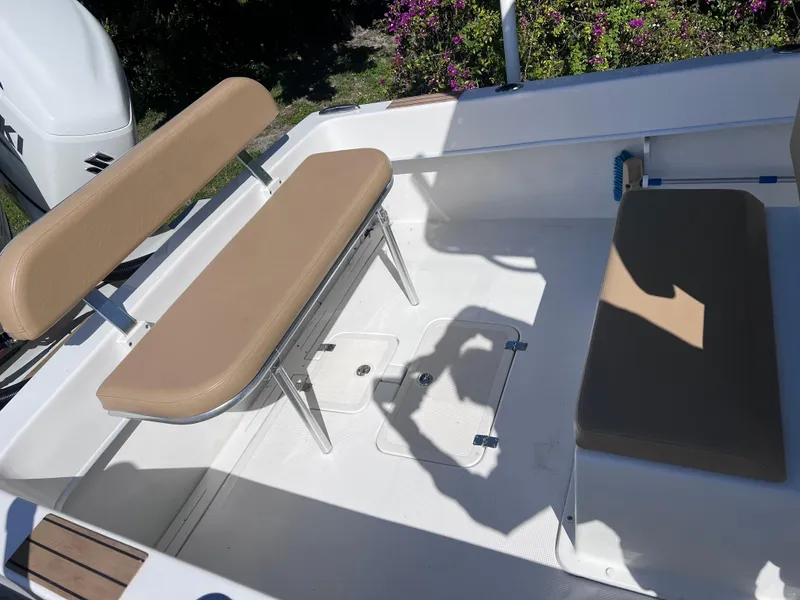 Slide: The Image of Dusky 278 Center Console 2022 boat interior with tan seating and white deck. - 16
