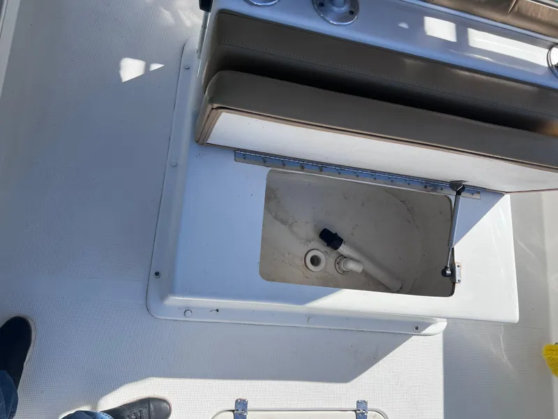 Slide: The Image of 2022 Dusky 278 Center Console boat interior with open storage compartment. - 17