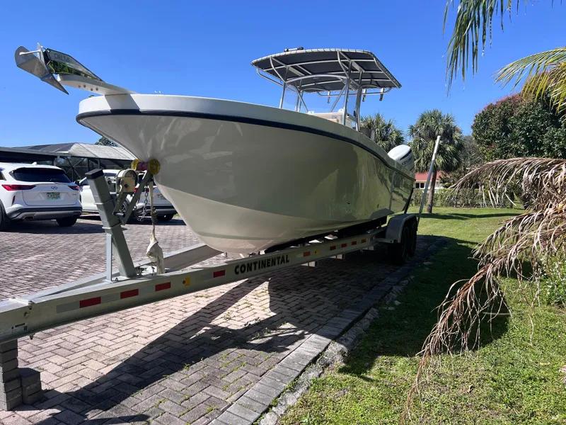 Slide: The Image of 2022 Dusky 278 Center Console boat on a Continental trailer in a driveway. - 4