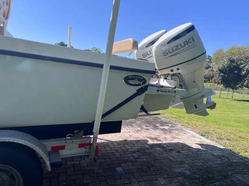 Slide: The Image of 2022 Dusky 278 Center Console boat with twin Suzuki outboard motors on a trailer. - 6