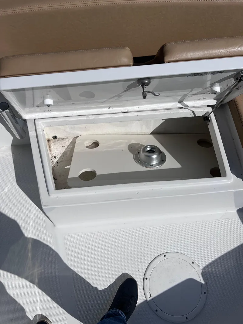 Slide: The Image of Open storage compartment on a 2022 Dusky 278 Center Console boat. - 9