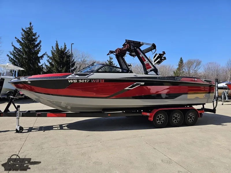 Slide: The Image of 2021 Centurion Ri265 boat on a trailer, red and gray color scheme. - 10