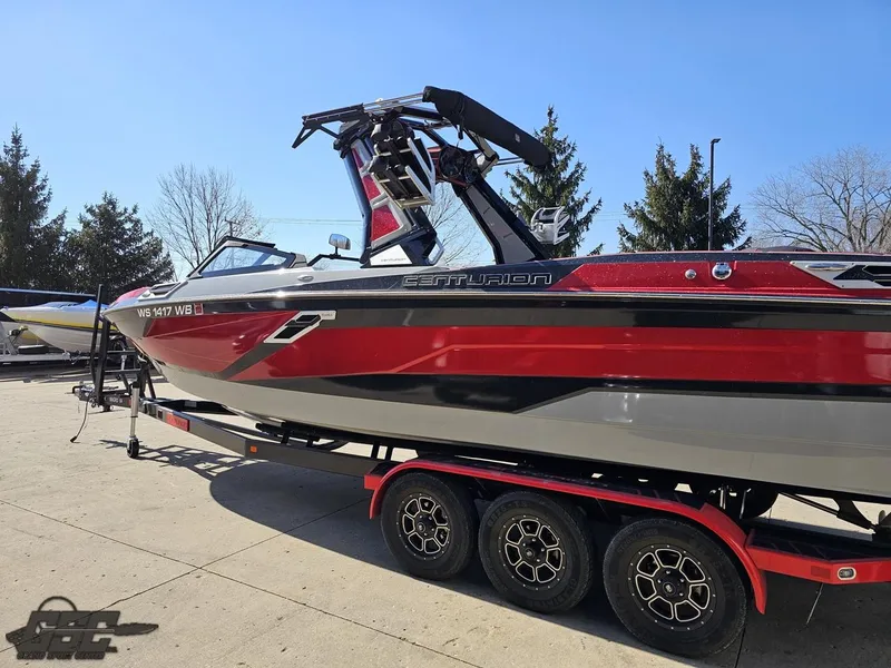 Slide: The Image of 2021 Centurion Ri265 boat on a trailer, red and gray exterior. - 13