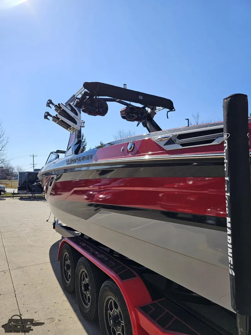 Slide: The Image of 2021 Centurion Ri265 boat with red and white exterior on a trailer. - 15