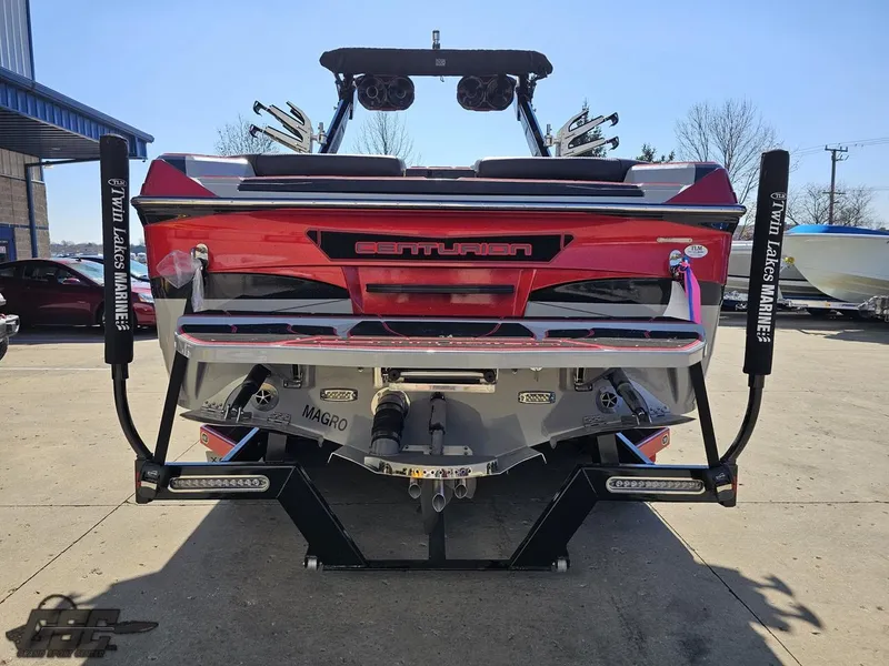 Slide: The Image of 2021 Centurion Ri265 boat rear view with wakeboard racks and trailer. - 16