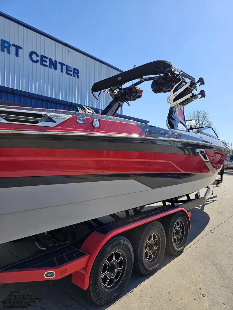 Slide: The Image of 2021 Centurion Ri265 boat with red and black detailing on a trailer. - 18