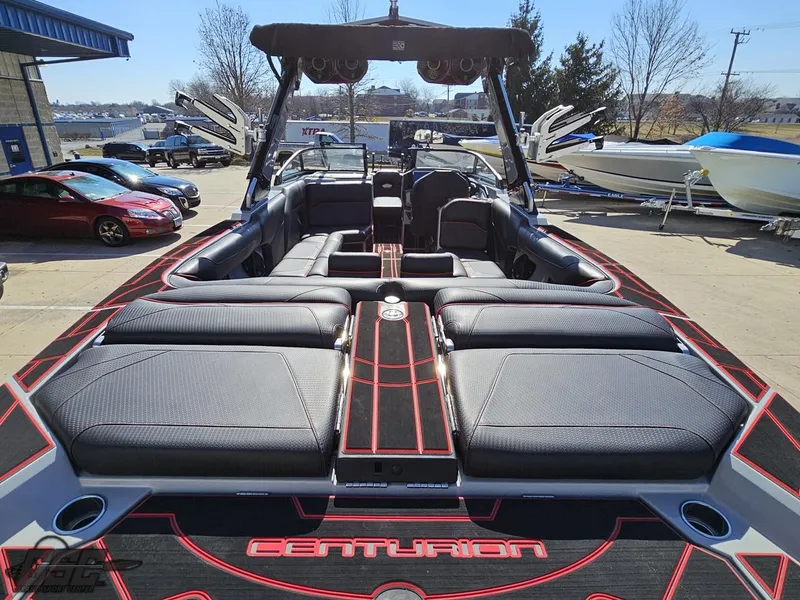 Slide: The Image of 2021 Centurion Ri265 boat with spacious seating and sleek design in a marina. - 21