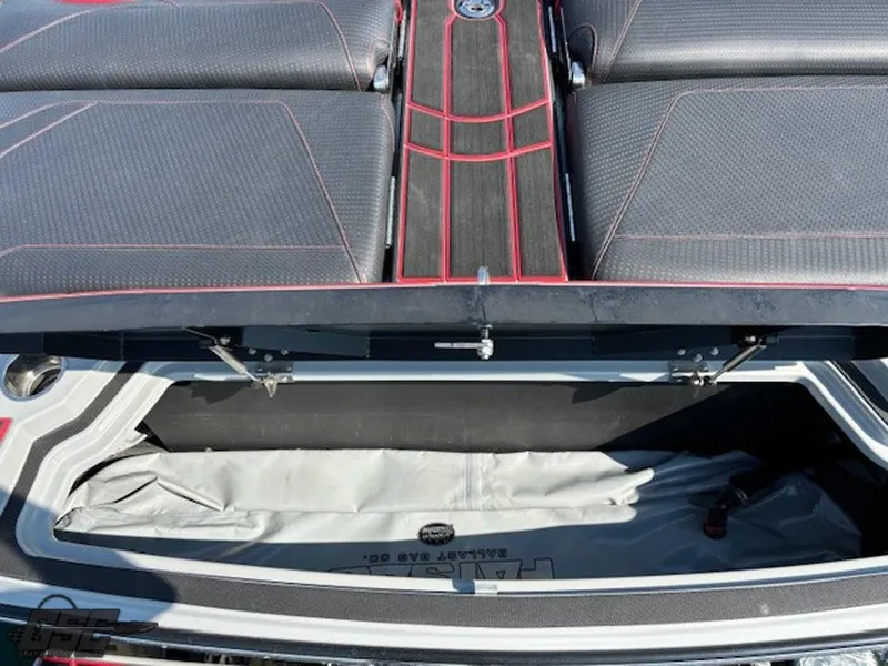 Slide: The Image of 2021 Centurion Ri265 boat storage compartment with cushioned seating and red accents. - 22