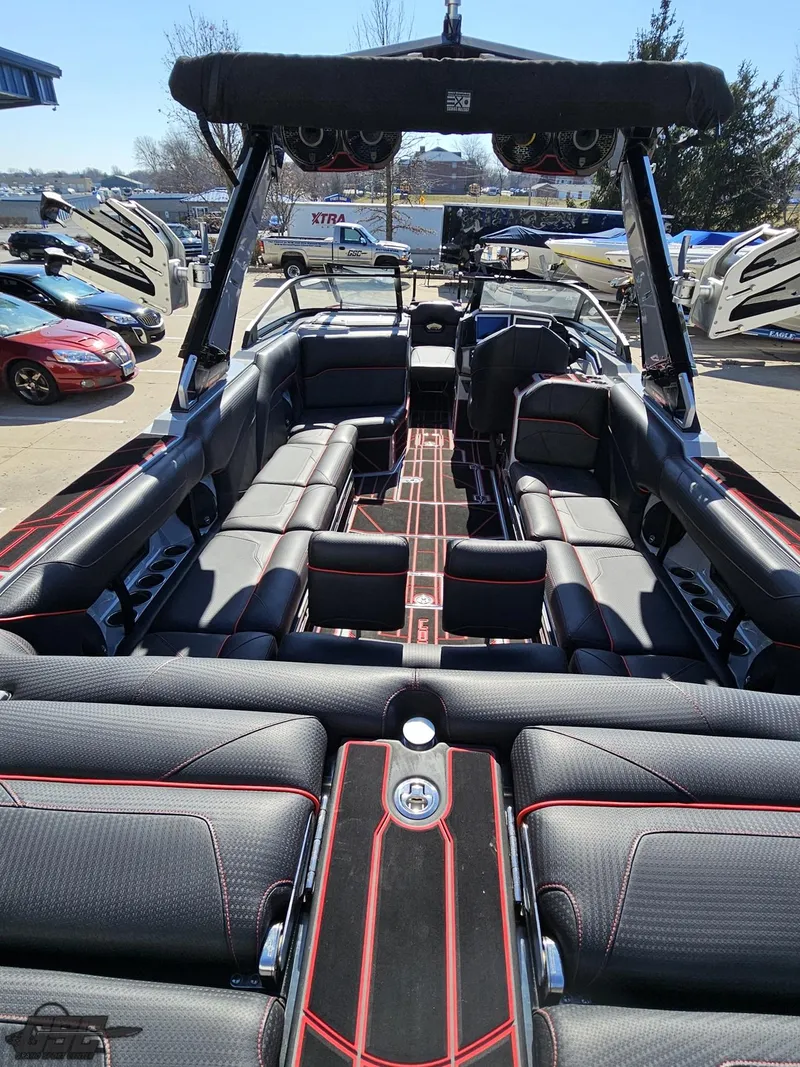 Slide: The Image of 2021 Centurion Ri265 boat interior with black and red seating, open layout, and modern design. - 24