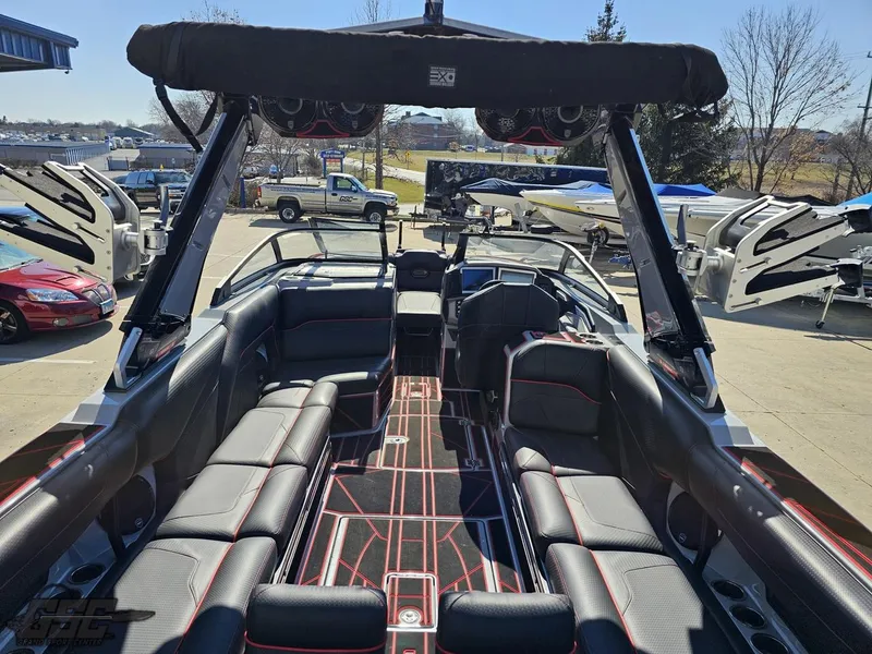 Slide: The Image of 2021 Centurion Ri265 boat interior with black and red seating, docked at marina. - 27