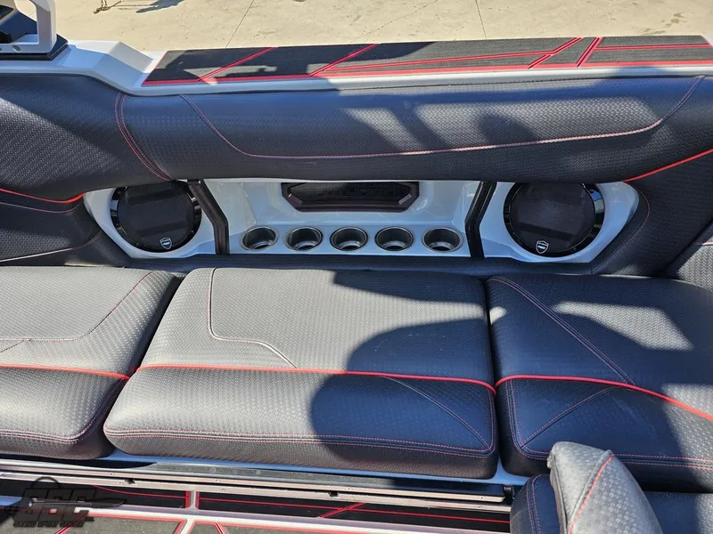 Slide: The Image of 2021 Centurion Ri265 boat interior with black and red seating and built-in speakers. - 32