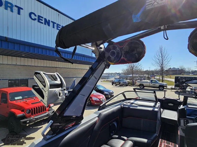 Slide: The Image of 2021 Centurion Ri265 boat with speakers and wakeboard rack at a sport center. - 37