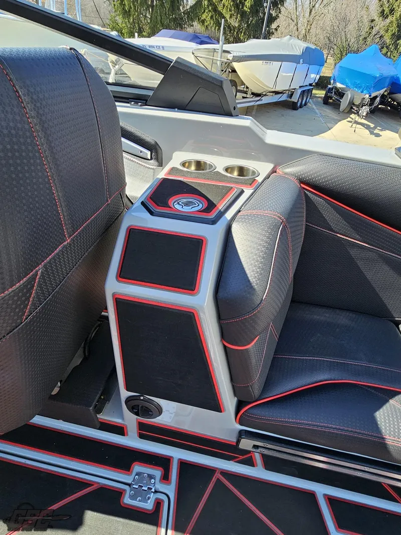 Slide: The Image of 2021 Centurion Ri265 boat interior with black and red seating and cup holders. - 42