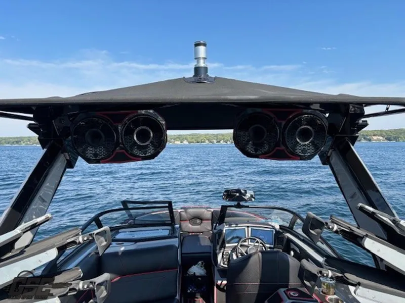 Slide: The Image of 2021 Centurion Ri265 boat interior with speakers on a lake. - 48