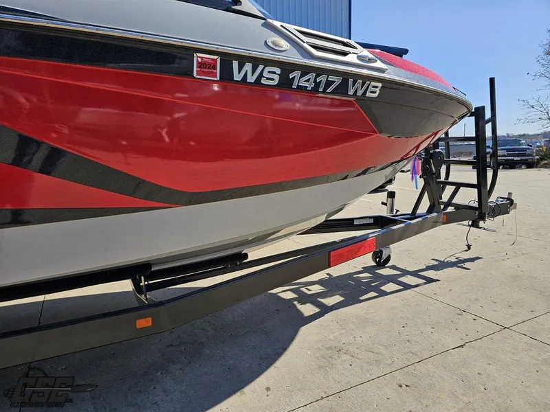 Slide: The Image of 2021 Centurion Ri265 boat on a trailer, red and black design. - 6