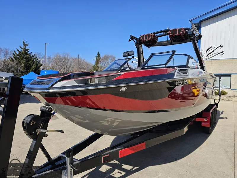 Slide: The Image of 2021 Centurion Ri265 boat on a trailer, red and black exterior. - 9