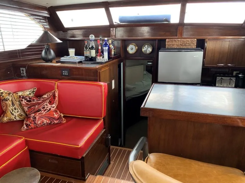Slide: The Image of Interior of 1969 Chris-Craft 46 Roamer with red seating, bar area, and mini-fridge. - 1
