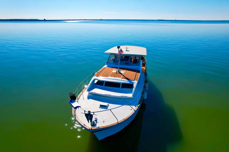 Slide: The Image of 1969 Chris-Craft 46 Roamer yacht cruising on calm blue waters. - 15