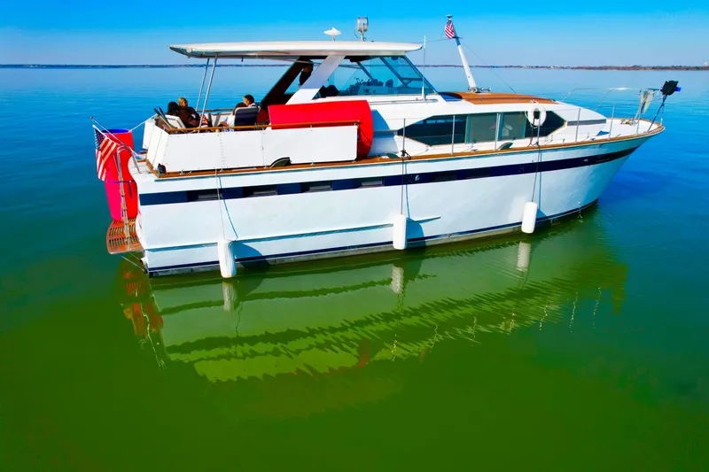 Slide: The Image of 1969 Chris-Craft 46 Roamer yacht on calm green water with clear blue sky. - 19