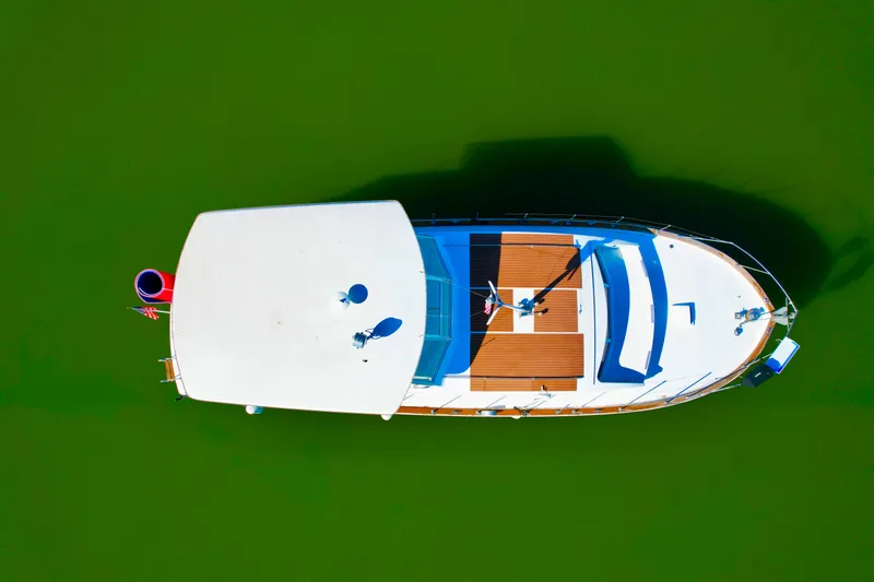 Slide: The Image of Aerial view of 1969 Chris-Craft 46 Roamer yacht on green water. - 21