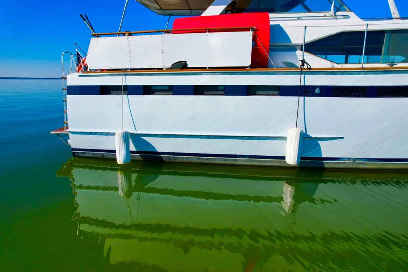 Slide: The Image of 1969 Chris-Craft 46 Roamer yacht on calm green water. - 22