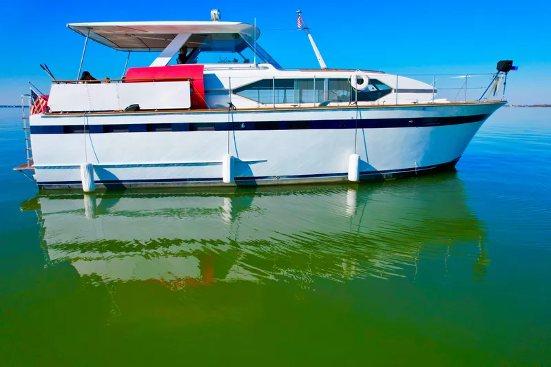 Slide: The Image of 1969 Chris-Craft 46 Roamer yacht on calm green water under clear blue sky. - 23