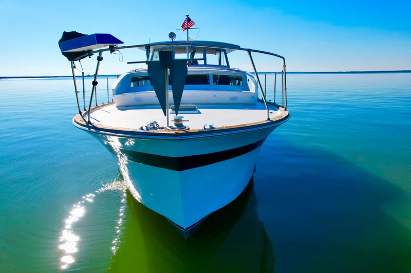 Slide: The Image of 1969 Chris-Craft 46 Roamer yacht on calm water with clear blue sky. - 24
