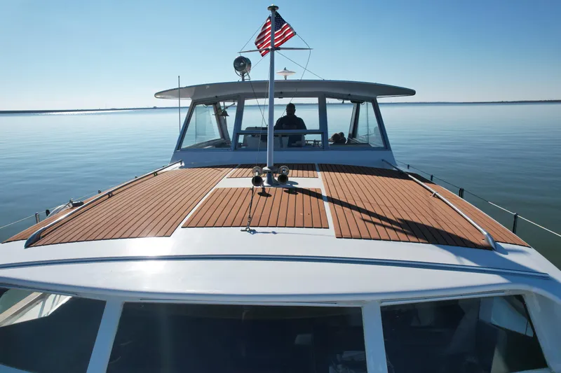 Slide: The Image of 1969 Chris-Craft 46 Roamer yacht on calm waters with American flag. - 26