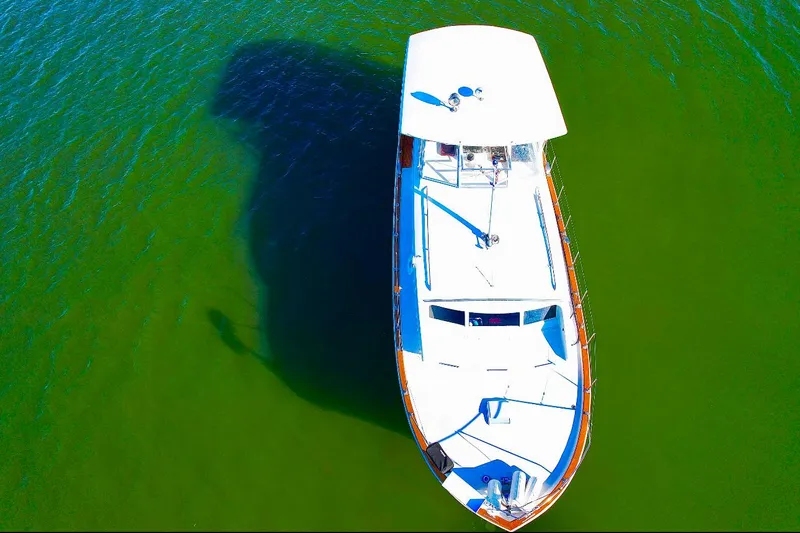 Slide: The Image of Aerial view of 1969 Chris-Craft 46 Roamer boat on green water. - 28