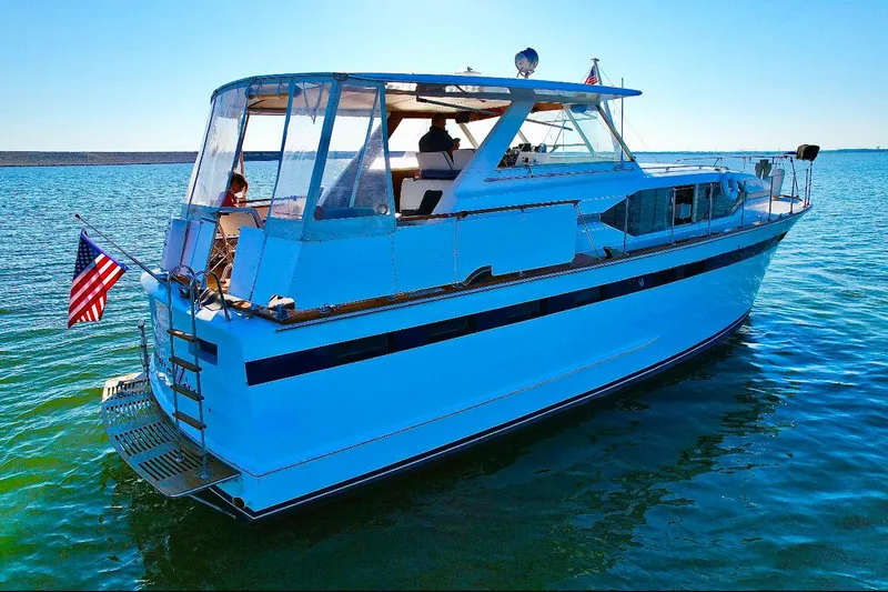 Slide: The Image of 1969 Chris-Craft 46 Roamer yacht on calm water, rear view. - 29
