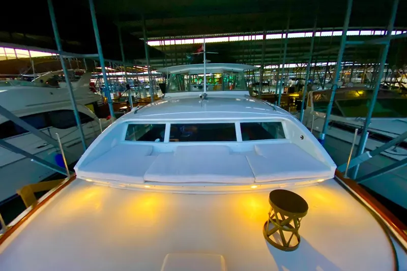 Slide: The Image of 1969 Chris-Craft 46 Roamer yacht docked in a marina, illuminated deck. - 34