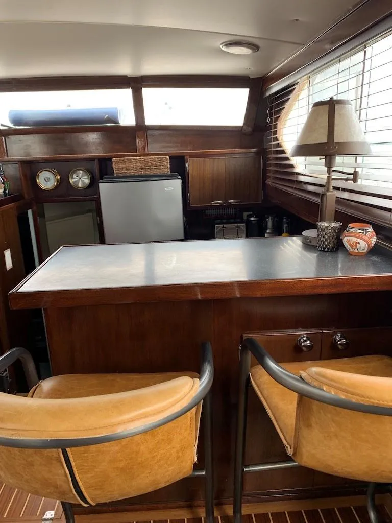Slide: The Image of 1969 Chris-Craft 46 Roamer yacht interior with bar stools and kitchenette. - 7