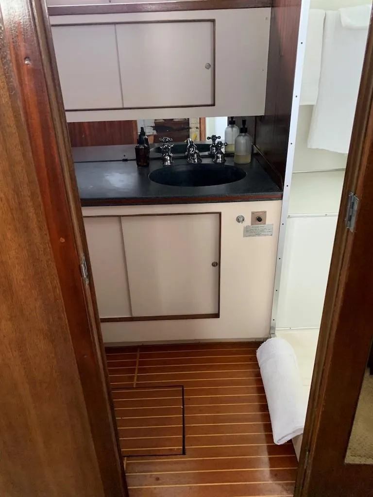 Slide: The Image of 1969 Chris-Craft 46 Roamer bathroom with wooden flooring and modern sink. - 9