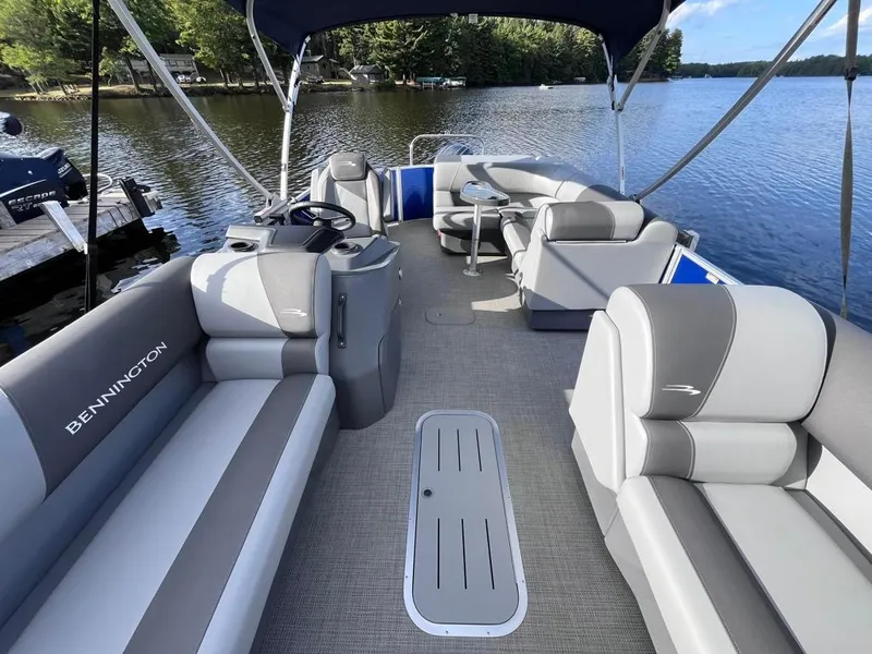 Slide: The Image of 2024 Bennington 22SVL-SPS pontoon boat interior on a serene lake. - 12