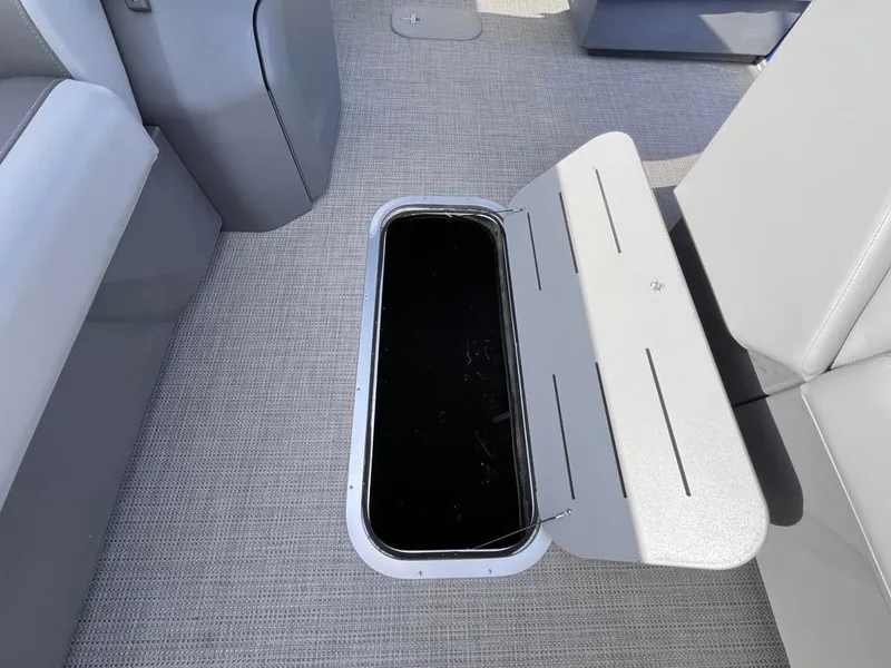 Slide: The Image of 2024 Bennington 22SVL-SPS boat interior with open storage compartment. - 14