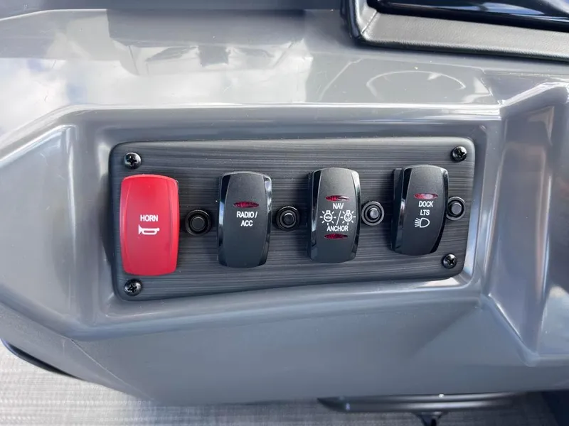 Slide: The Image of 2024 Bennington 22SVL-SPS boat control panel with horn, radio, navigation, and dock light switches. - 20