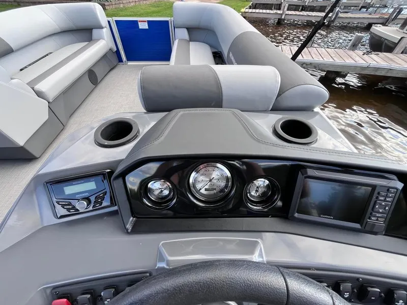 Slide: The Image of 2024 Bennington 22SVL-SPS boat dashboard with gauges, GPS, and seating. - 21