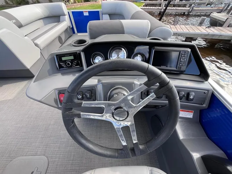 Slide: The Image of 2024 Bennington 22SVL-SPS boat dashboard with steering wheel and control panel. - 28
