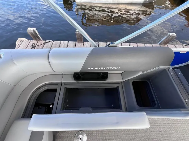 Slide: The Image of 2024 Bennington 22SVL-SPS boat interior with storage compartment, docked by the water. - 32