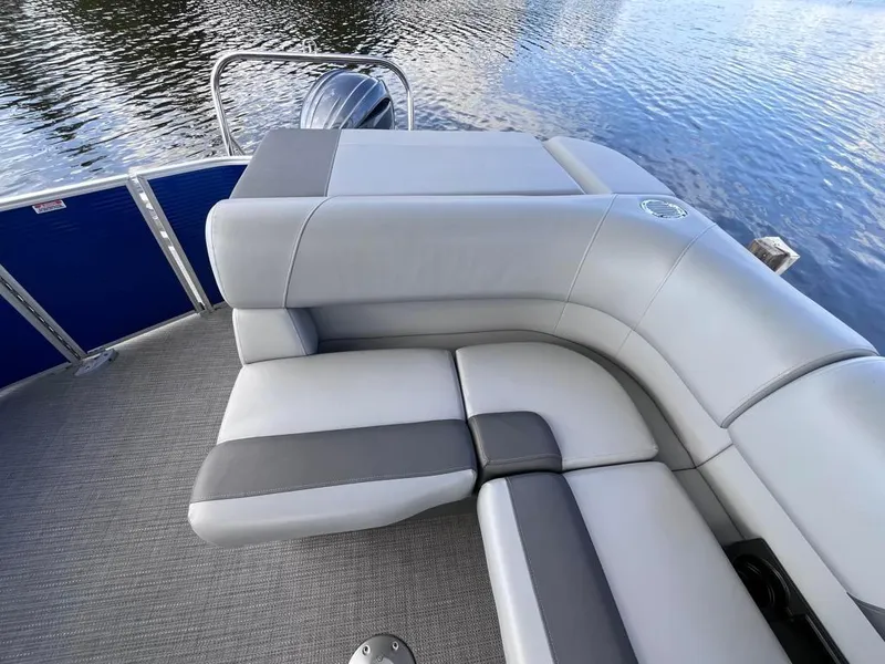 Slide: The Image of 2024 Bennington 22SVL-SPS pontoon boat with luxurious seating on calm water. - 33