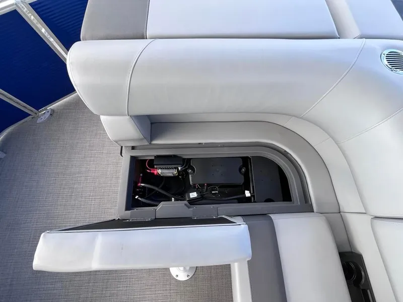 Slide: The Image of 2024 Bennington 22SVL-SPS boat seat storage compartment open, revealing internal components. - 34