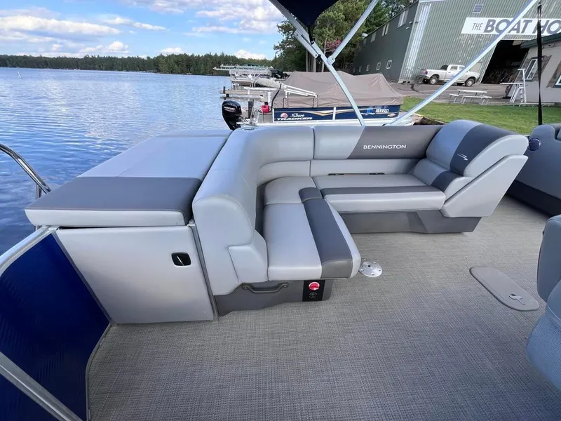 Slide: The Image of 2024 Bennington 22SVL-SPS pontoon boat with spacious seating on a serene lake. - 35